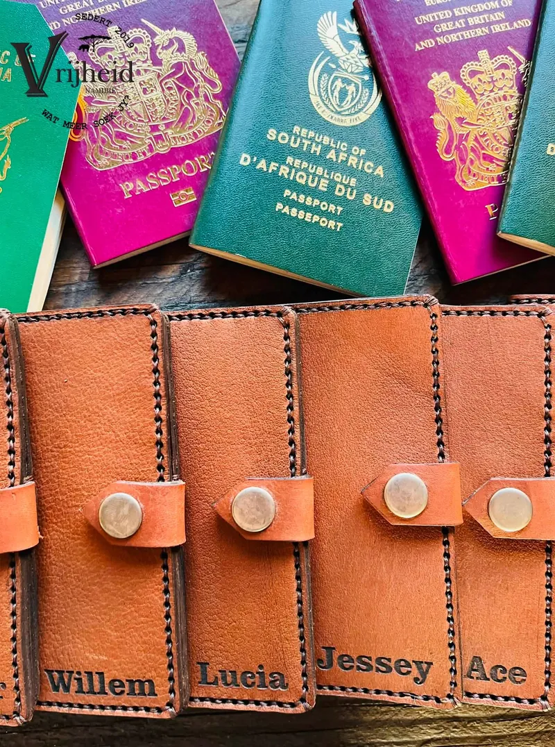 Four leather document covers, each engraved with a different name